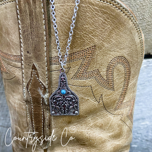 Tooled Silver & Turquoise Accent Cowtag Necklace