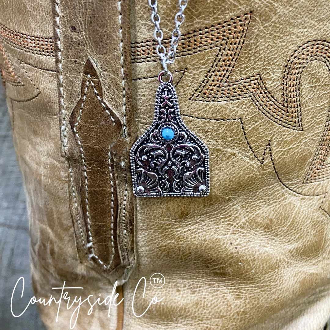 Tooled Silver & Turquoise Accent Cowtag Necklace